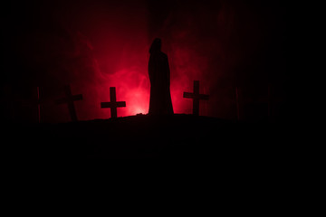 Fototapeta na wymiar Girl walking alone in the cemetery at night.