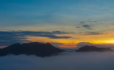 Landscape morning mist of the mountains, beautiful mist and light of the sunrise.