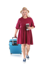 Senior woman with suitcase and passport on white background. Vacation travel