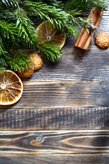 Obraz na płótnie Canvas Christmas and new year background frame or postcard Christmas composition with fir branches dried oranges cookies cinnamon sticks on a wooden background