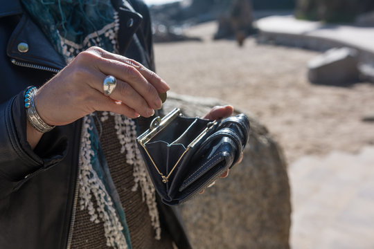 Woman using her purse and her modern backpack