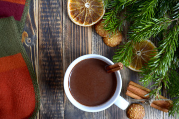 Hot chocolate or cocoa with cinnamon stick in a cup and fir branches. Winter hot drink for cold weather. New year and Christmas concept Top view