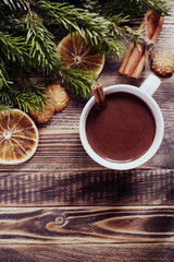Hot chocolate or cocoa with cinnamon stick in a cup and fir branches. Winter hot drink for cold weather. New year and Christmas concept Top view Copy space