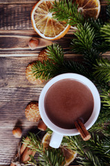 Obraz na płótnie Canvas Hot chocolate or cocoa with cinnamon stick in a cup and fir branches. Winter hot drink for cold weather. New year and Christmas concept Copy space