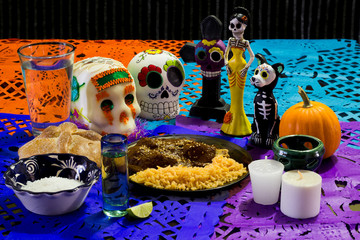 Ofrenda de día de muertos. Con calavera de azúcar, pan de muerto y platillo tradicional mexicano
