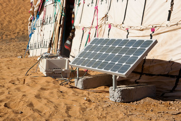 Solar panel and Berber tents in the dunes of Merzouga in Morocco