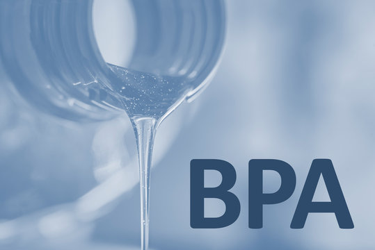 Plastic bottle and liquid stream. Bisphenol, text BPA FREE plastic photo