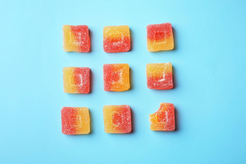 Flat lay composition with delicious colorful candies on color background