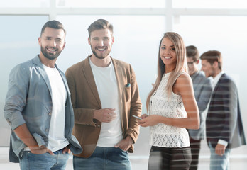 Obraz premium three young employees of the company standing in the office
