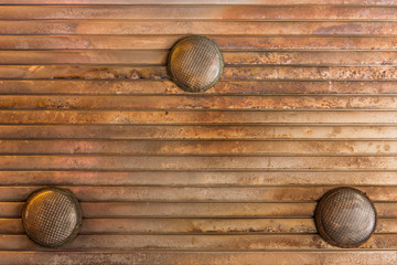 Background texture of corrugated rusty metal ceiling equipped with three bulbs on underpass Yurakucho Concourse under the railway line of the station Yurakucho.