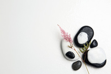 Flat lay composition with spa stones and space for text on white background