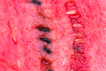Juicy red flesh of a watermelon with seeds. 