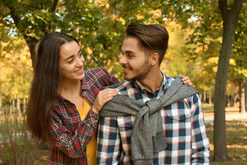 Fototapeta premium Young lovely couple spending time together in park. Autumn walk