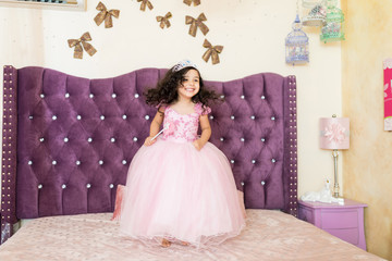 Little Girl In Royal Costume On Bed