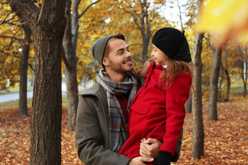 Father and his cute daughter spending time together in park. Autumn walk