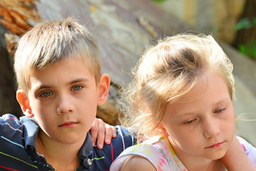 Children are near the ruined house, the concept of natural disaster, fire, and devastation.