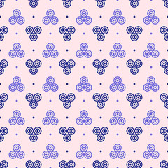 Blue and purple circles pattern on pale pink background