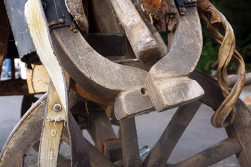 Old yoke for harnessing draft horses used on a farm. Accessories in an old stable.