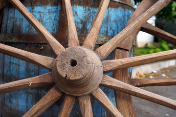 Closeup image of a vintage colored carriage wheels with blue  barrel