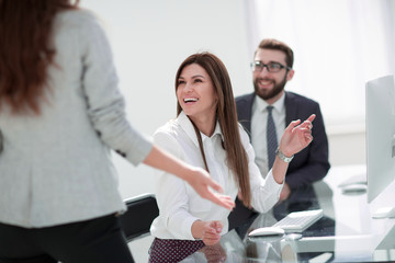 smiling employees talking in the workplace.