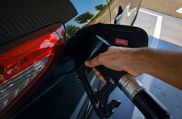 Close up man hand holding petrol pump nozzle