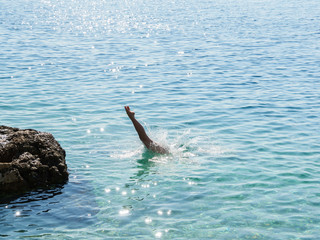 Young women jump into water in Croatia