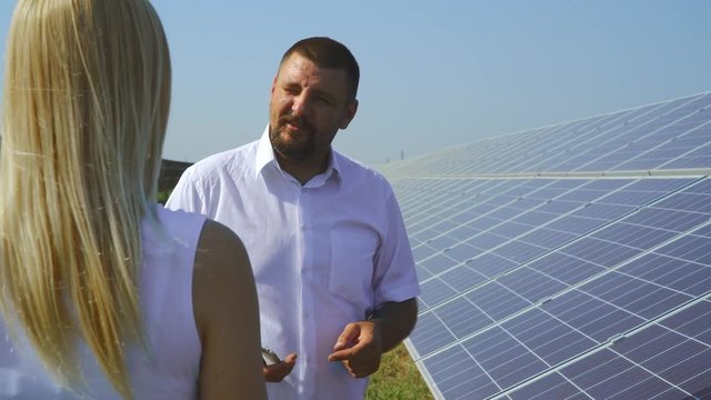 Couple talking at solar power plant