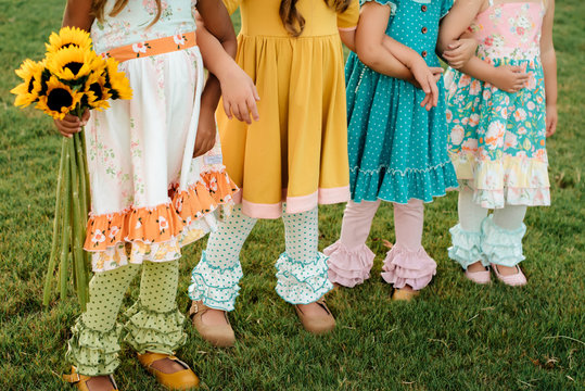 Children With Their Arms Linked Standing Outside