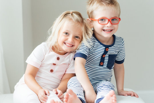 Smiling brother and sister sitting together