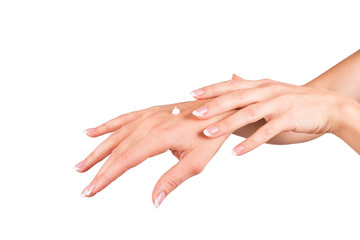 Female hands applying hand cream, white background, closeup