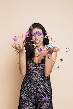 Happy woman with threw ticker tape