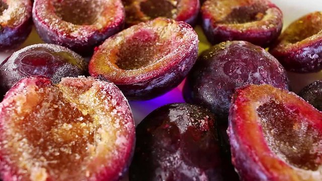Frosen plum plums purple half fruit rotating texture pattern closeup footage