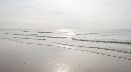 Beach along sea in sunlight at fall