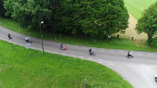 Aerial static footage of monkey bikes showing young people driving on these low-powered motorcycles made for convenience and ease of transportation their outstanding feature is a four-stroke engine 4k