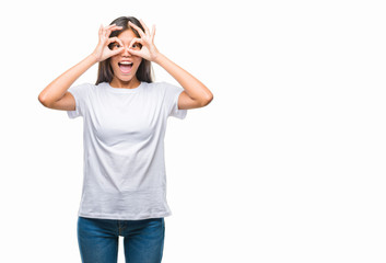 Fototapeta premium Young asian woman over isolated background doing ok gesture like binoculars sticking tongue out, eyes looking through fingers. Crazy expression.