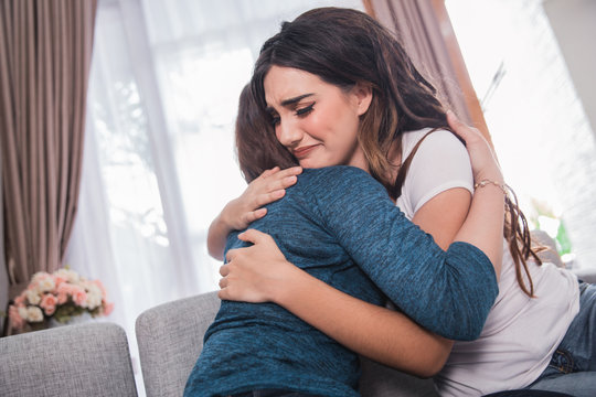 depressed woman being embrace by her friend