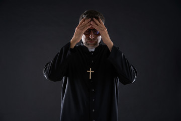 Priest male hands in head worried