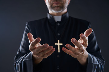 Priest open hands arms praying - obrazy, fototapety, plakaty