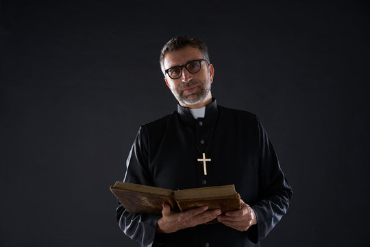 Priest portrait with Holy Bible in hands