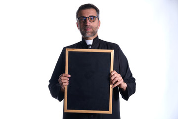 Priest holding empty blackboard copy space