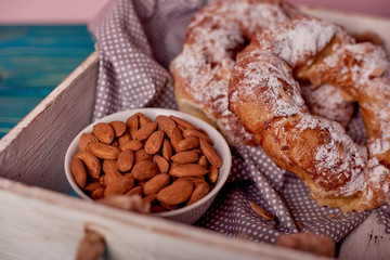A beautiful and tasty Kringle covered with almonds with cup of almonds, breakfast concept