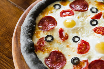 delicious pizza with meat, cheese and mushrooms	
