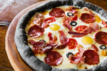 delicious pizza with meat, cheese and mushrooms	