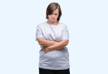 Young adult woman with down syndrome over isolated background skeptic and nervous, disapproving expression on face with crossed arms. Negative person.