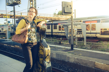 Young woman with the cello waiting for the train © eshana_blue