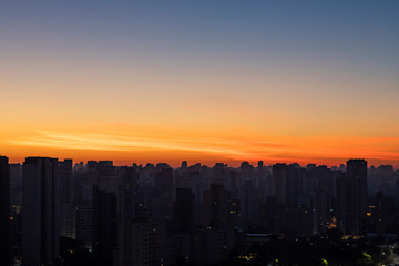 Fototapeta premium Big black city silhouette and sunset. Silhouette of the city of Sao Paulo, Brazil South America. 