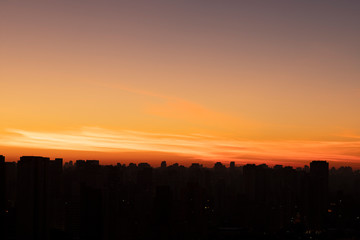 Obraz na płótnie Canvas Big black city silhouette and sunset. Silhouette of the city of Sao Paulo, Brazil South America. 