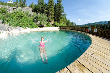 An adult female goes for a swim at Granite Creek Hot Springs, a natural hot spring in Jackson Hole, Wyoming. Fisheye view