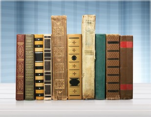 Ancient books in a row on wooden