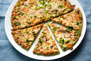 Spinach base pizza with broccoli, mozzarella and mushrooms 